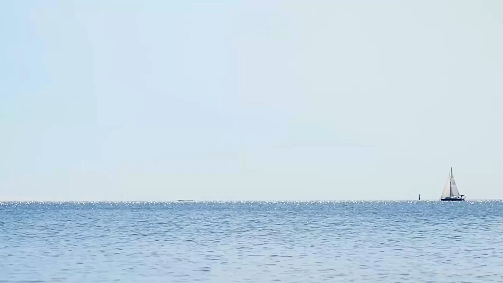 video of a sail boat in the horizon