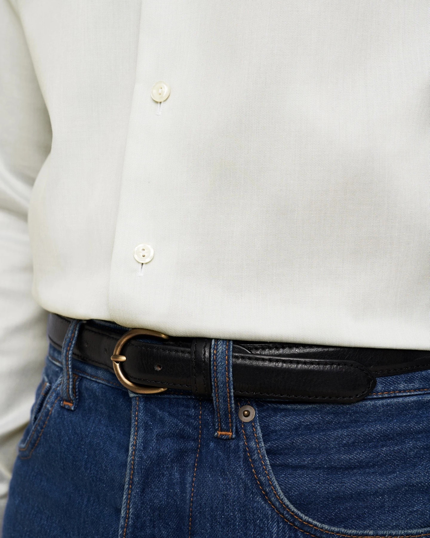 close up white shirt and belt on jeans