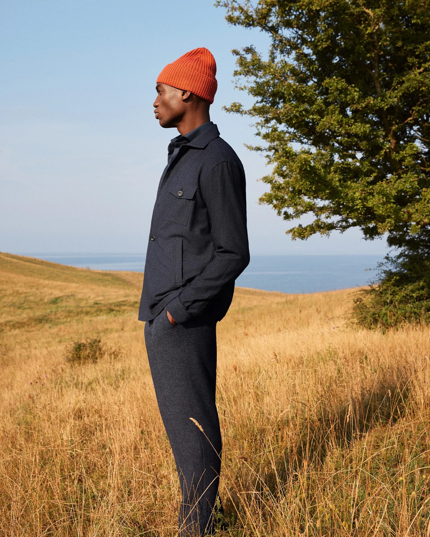 model wearing overshirt and orange beanie