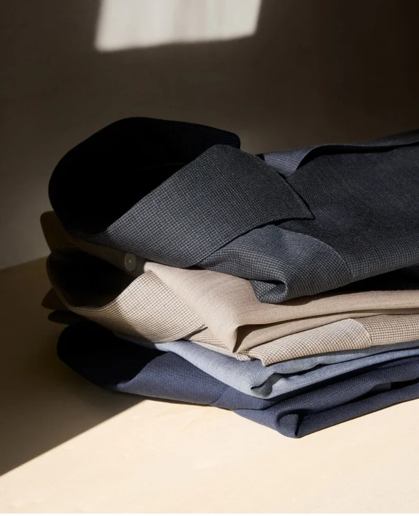 a pile of merino shirts on a table