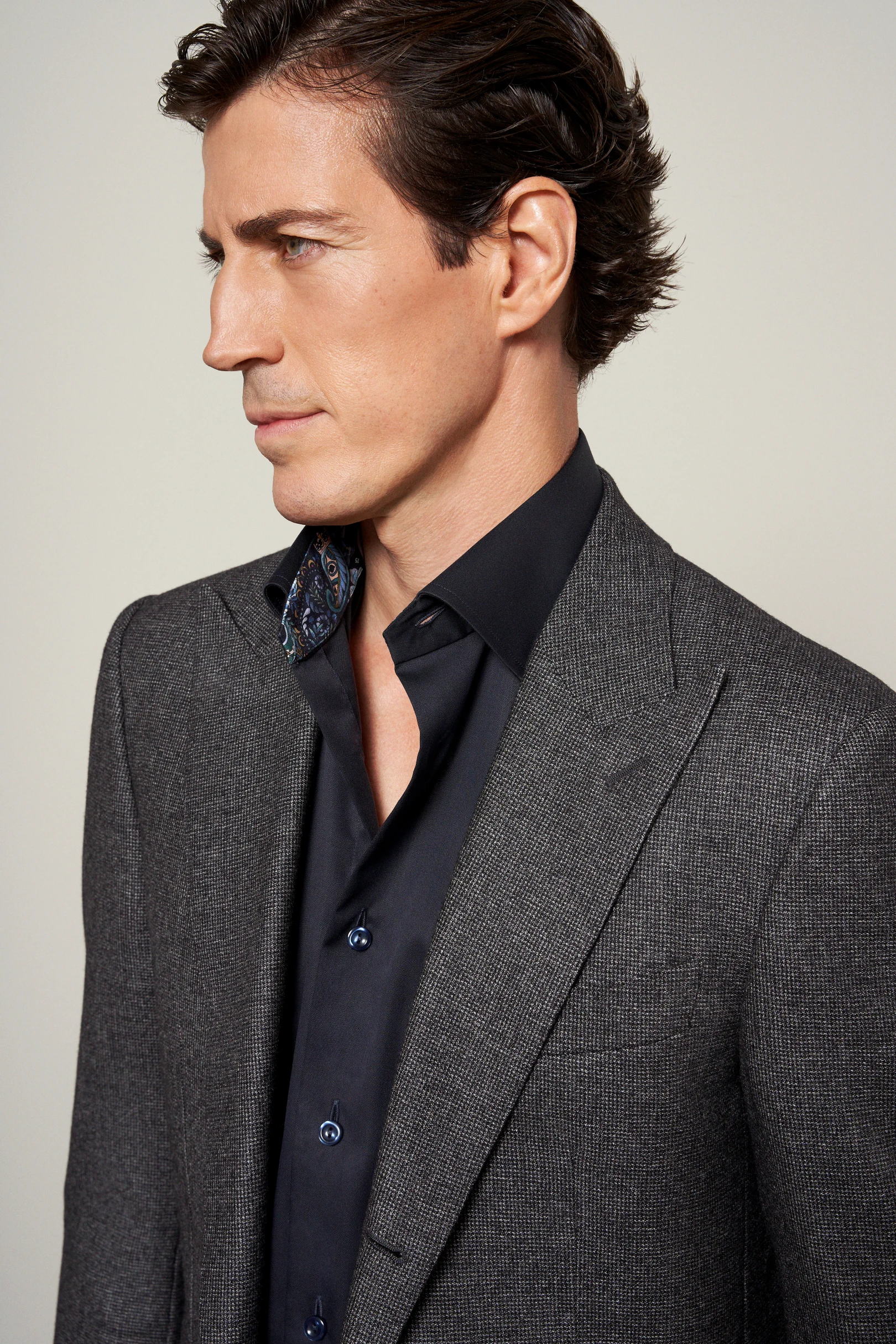 model in dark suit and shirt