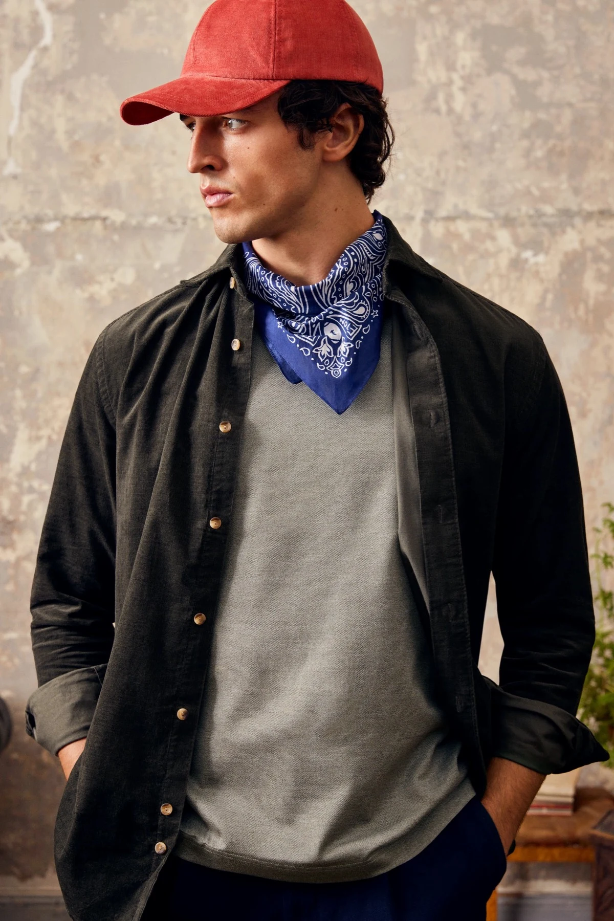 model wearing red cap and blue scarf casual styled