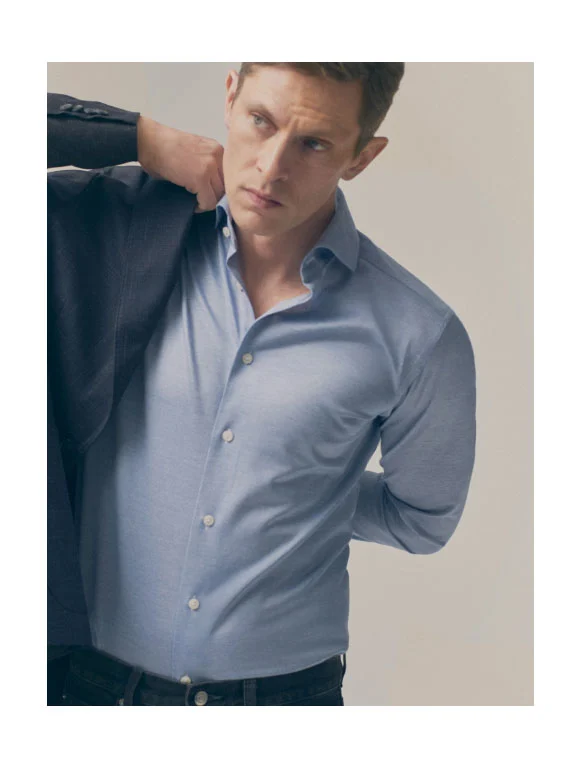 a guy putting on a soft jacket