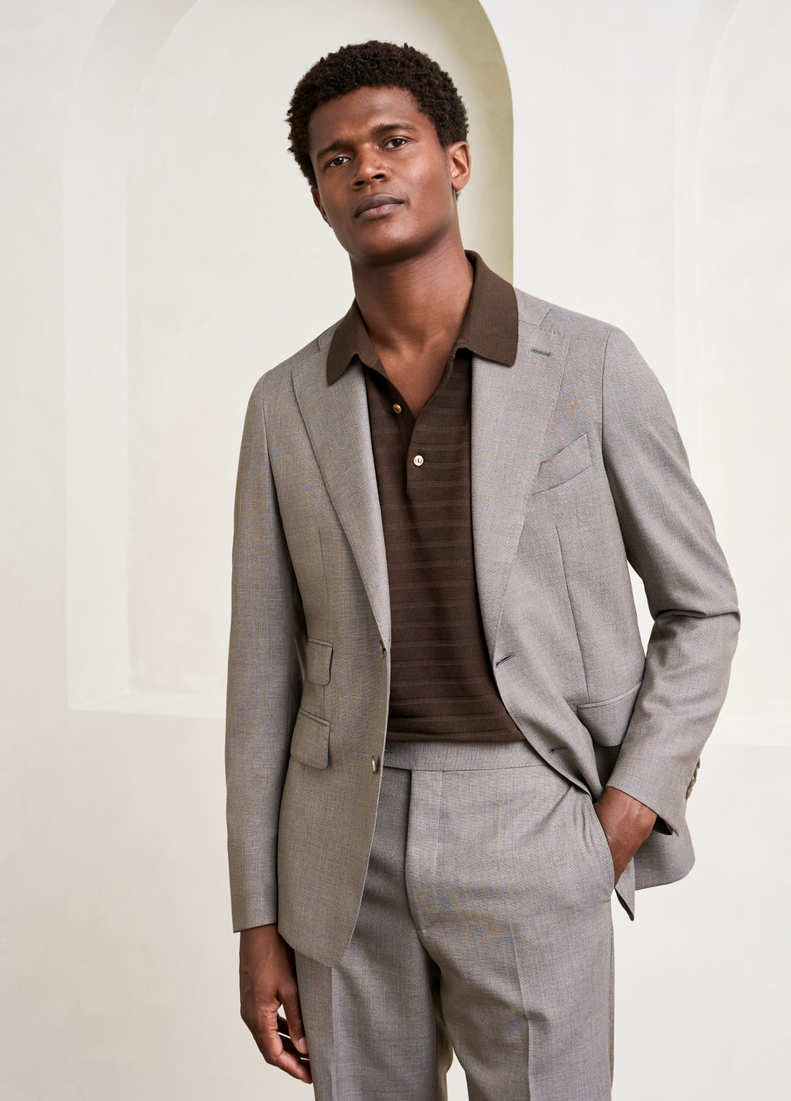model dressed in brown piké knit and suit