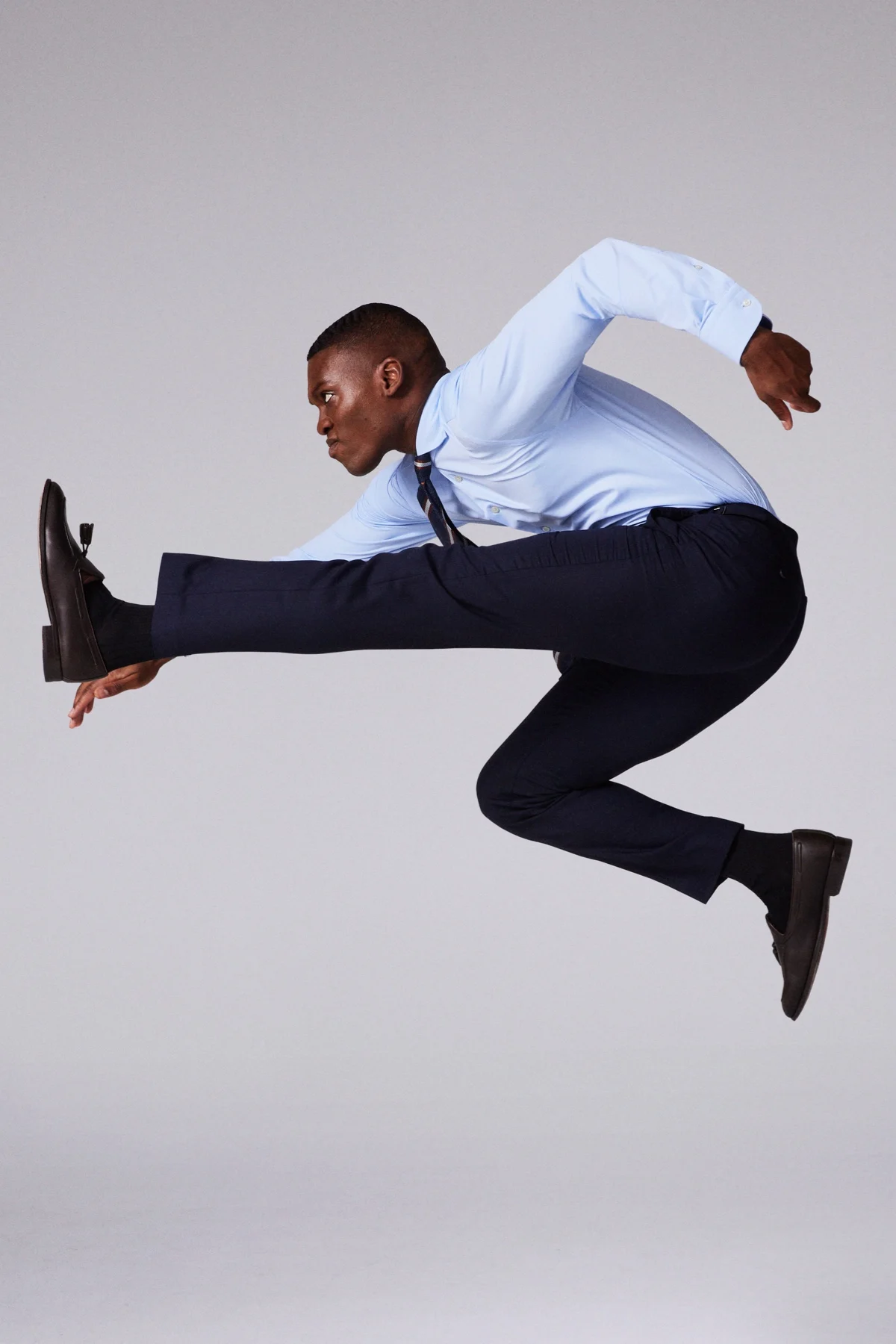 model jumping in blue shirt