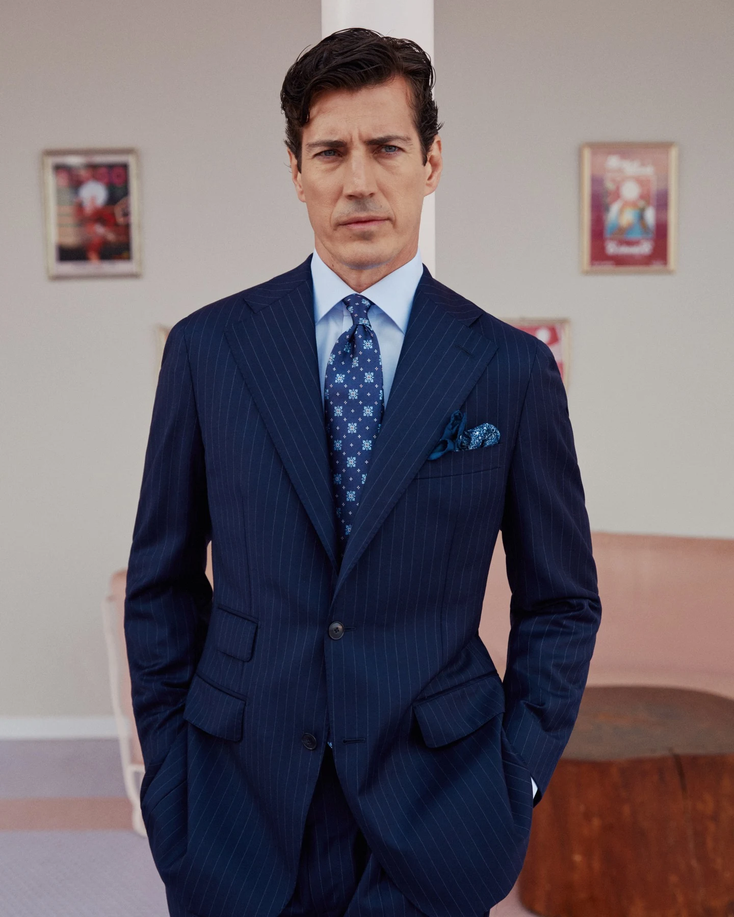 model in blue shirt navy suit and patterned tie and pocket square