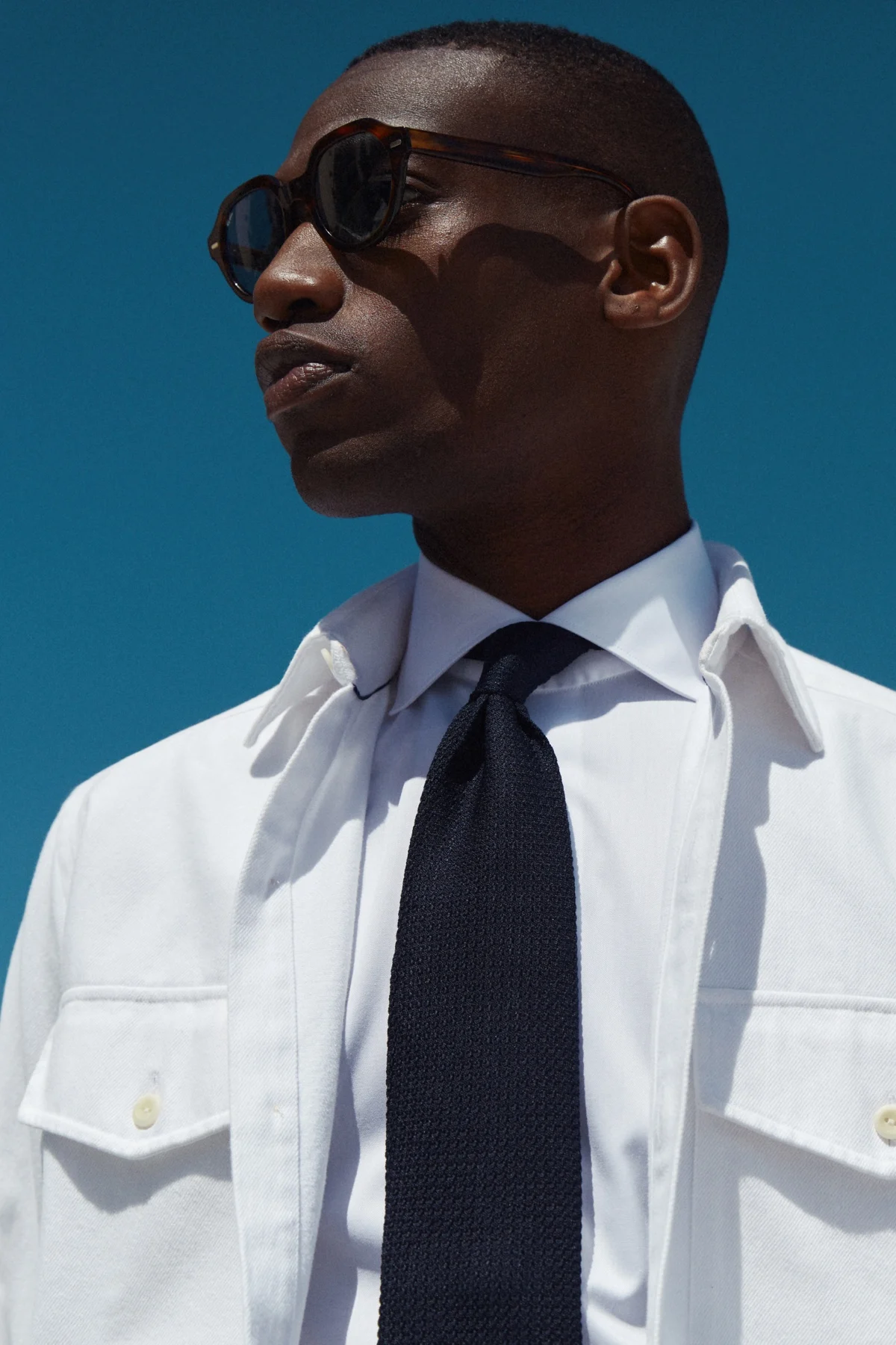 white overshirt styled on model with white shirt and tie
