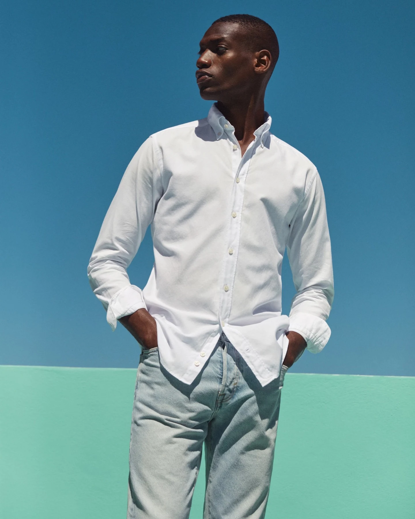 model in striped oxford shirt and jeans