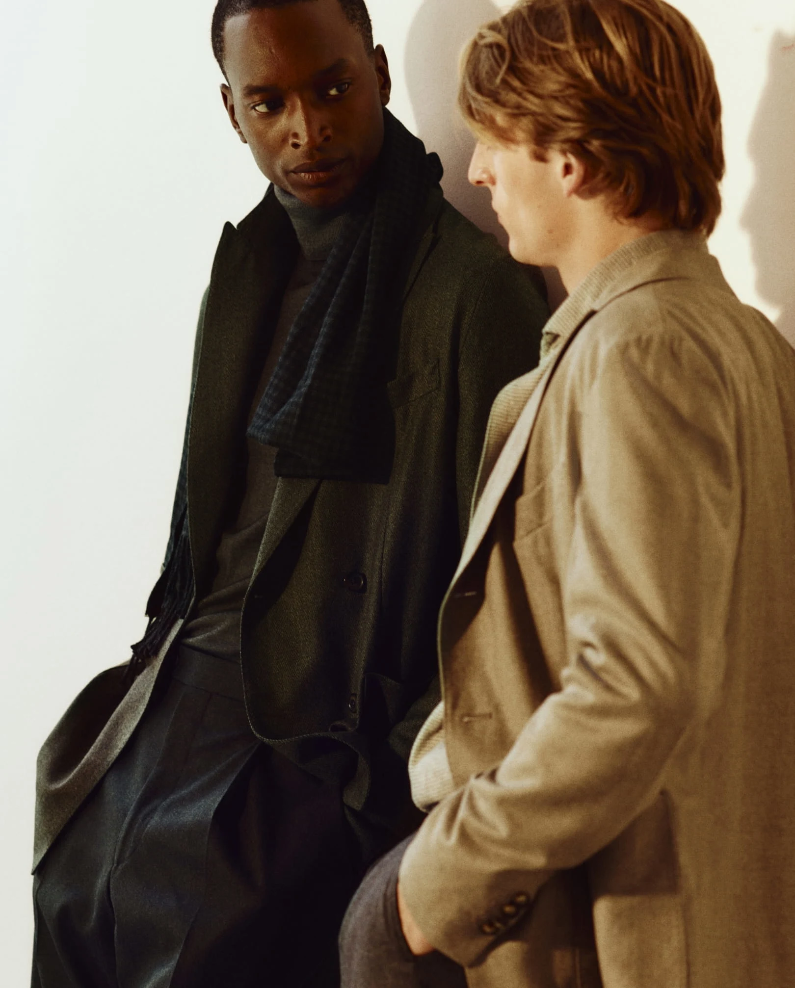 two men interacting wearing fall layerying pieces