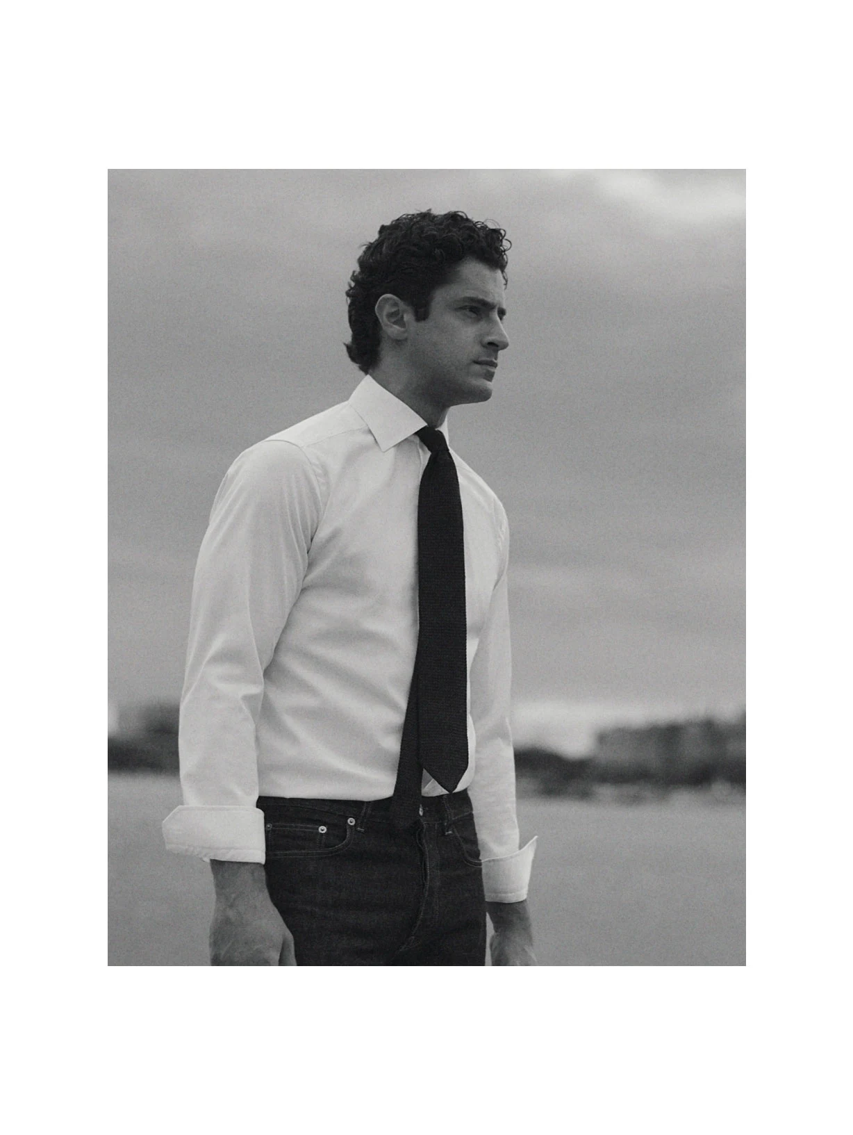 a man posing in a signature twill shirt with a tie