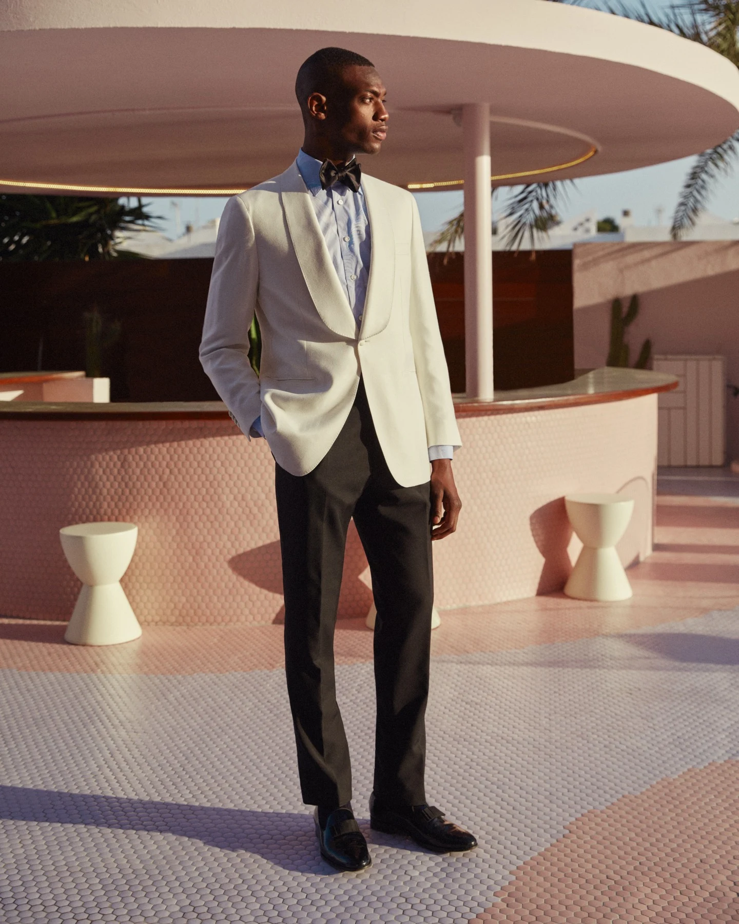 model in white tuxedo and shirt