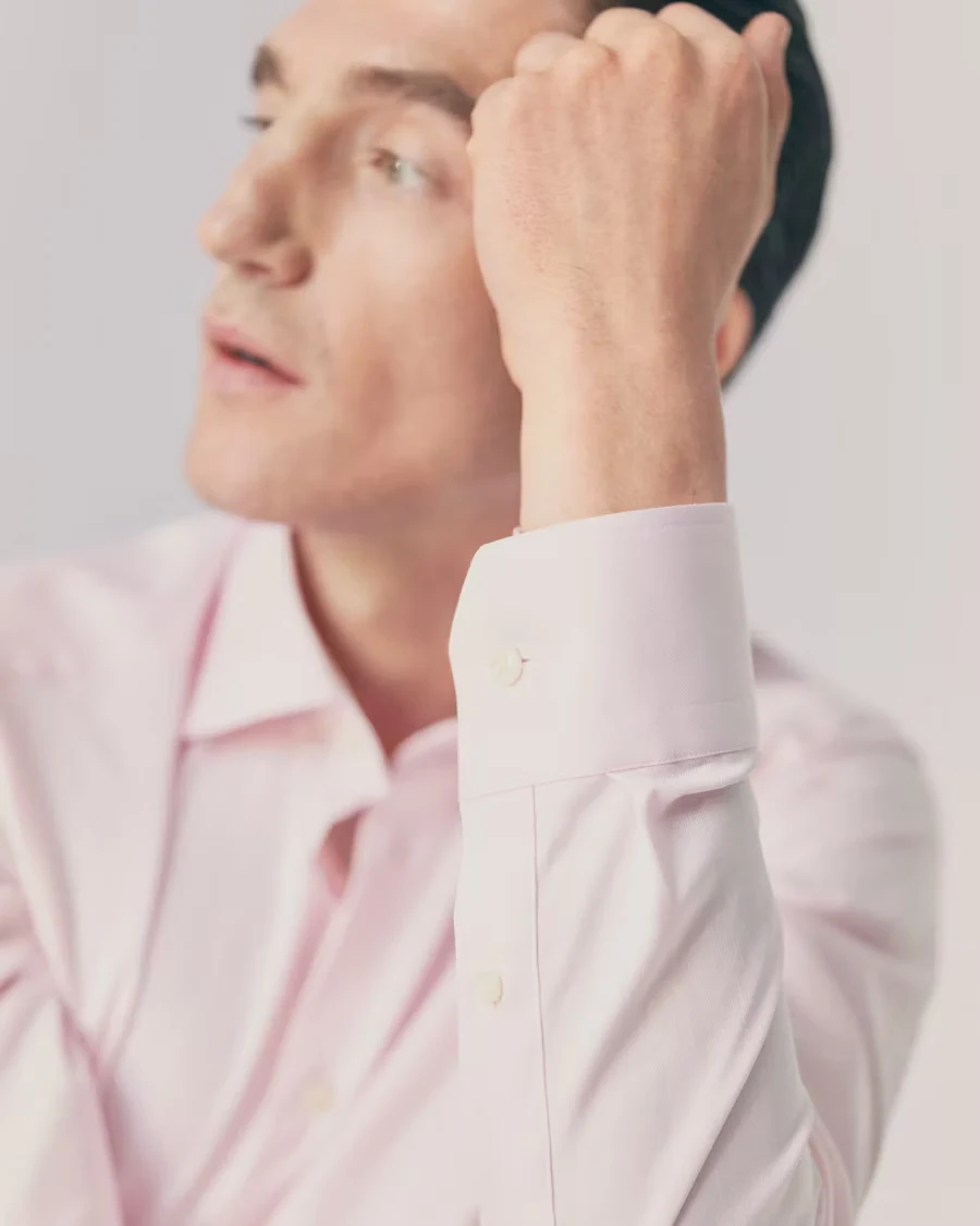 Man posing in a pink signature twill shirt highlighting the cuff