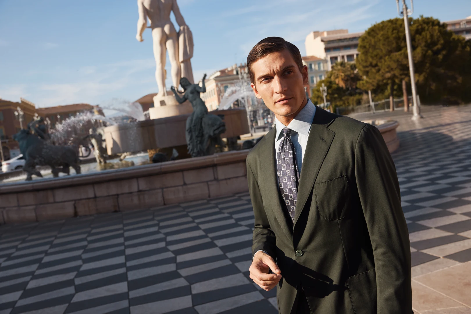 model in green shirt suit and tie