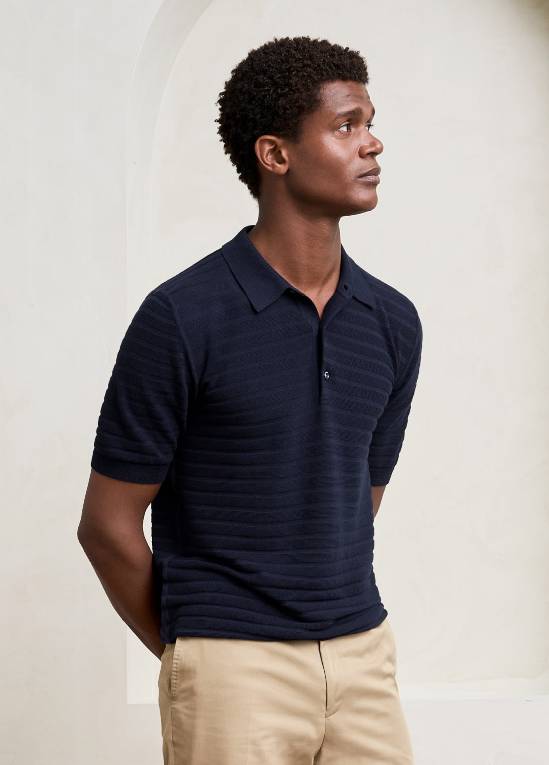 model in blue knit polo