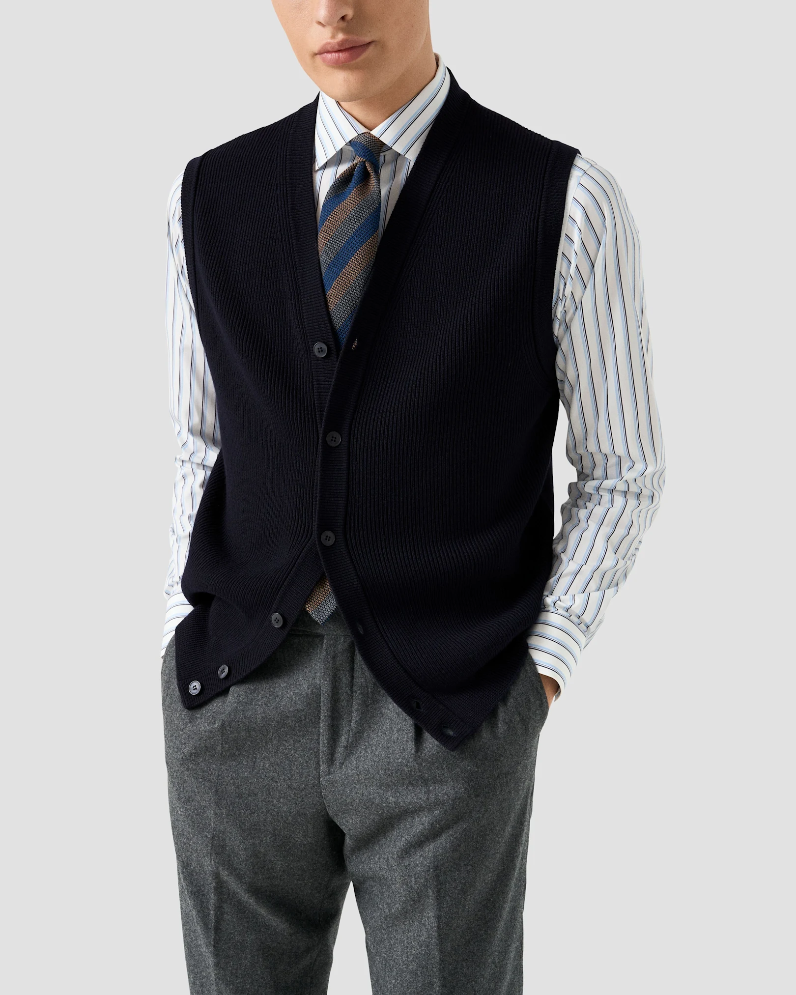 Navy knitted vest with dress shirt and tie