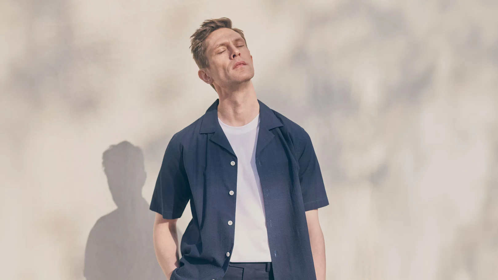 A model in a linen shirt posing