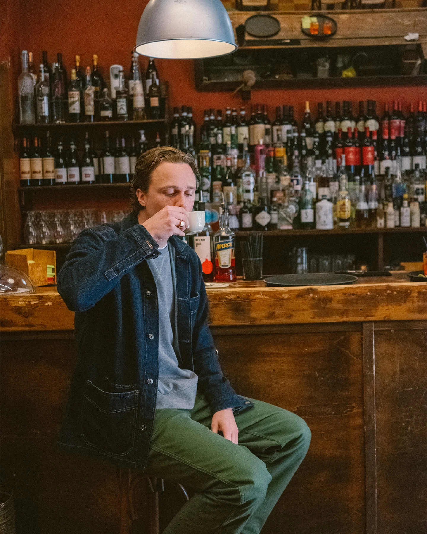 drinking coffee at bar model with eton jeansverket overshirt on