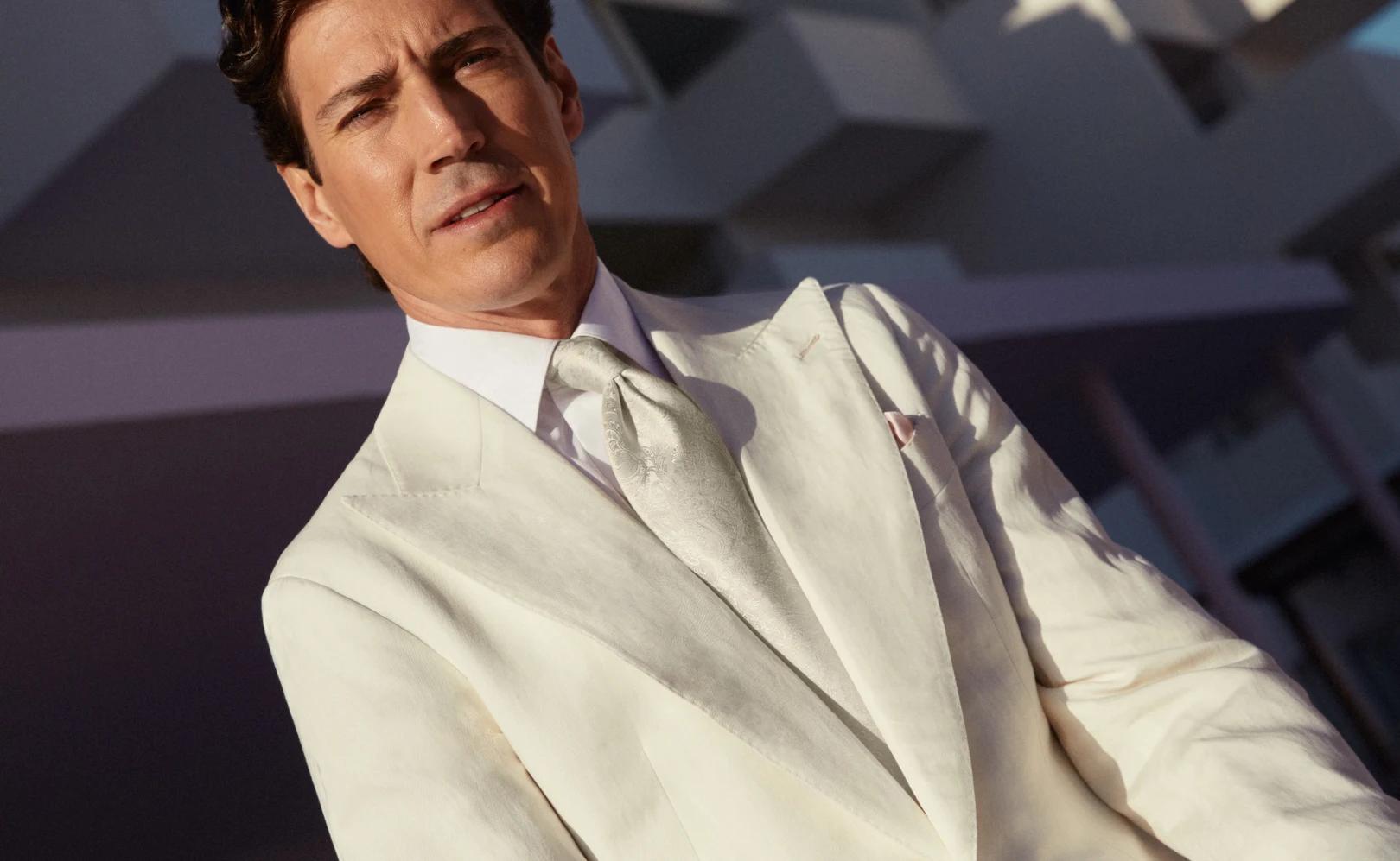 model with white suit and tie