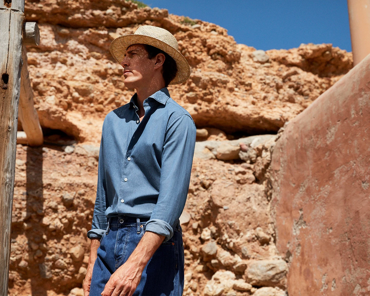 model in denim shirt and straw hat