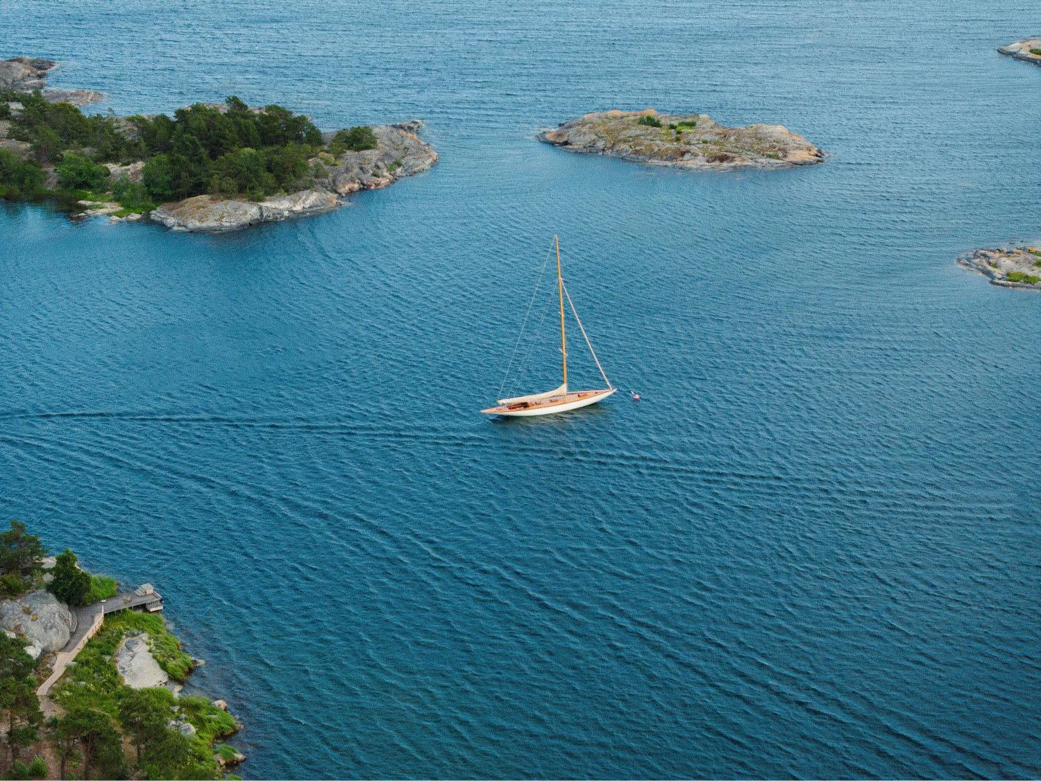 a sailing boat sailing through the beautiful archipelago