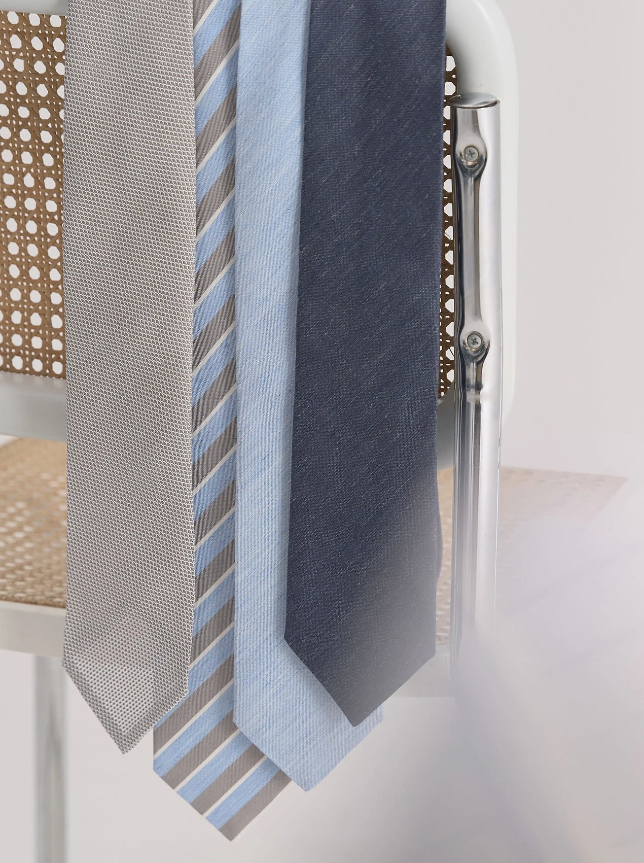 several ties hanging on a chair