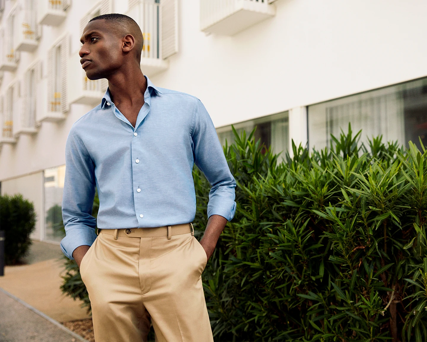 model in beige chinos and blue linen shirt