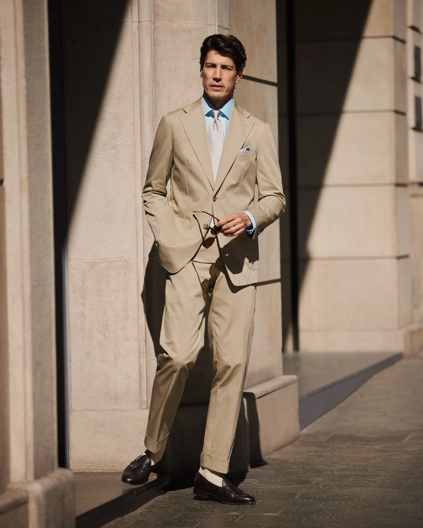 styled beige suit blue shirt patterned tie
