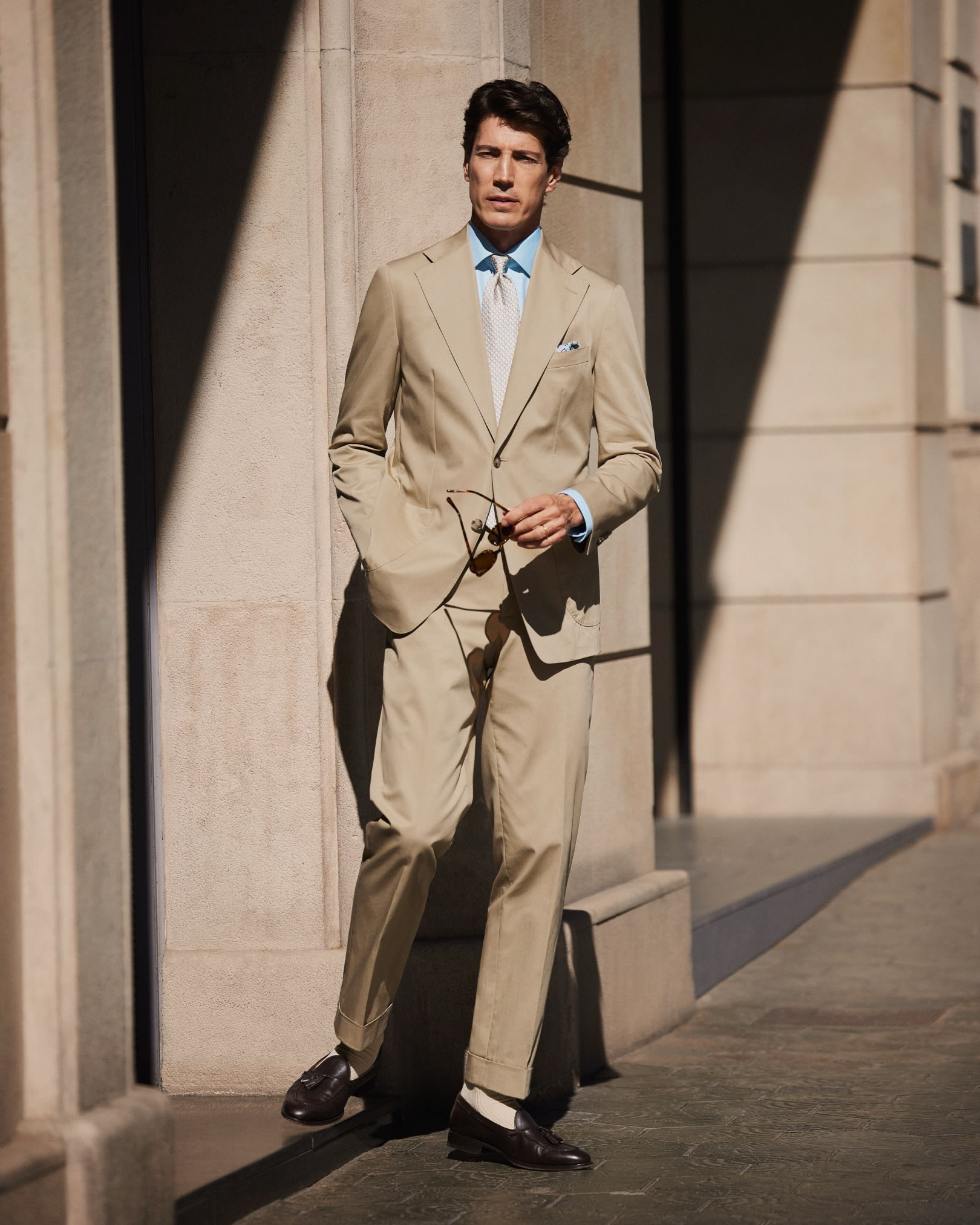 styled beige suit blue shirt patterned tie