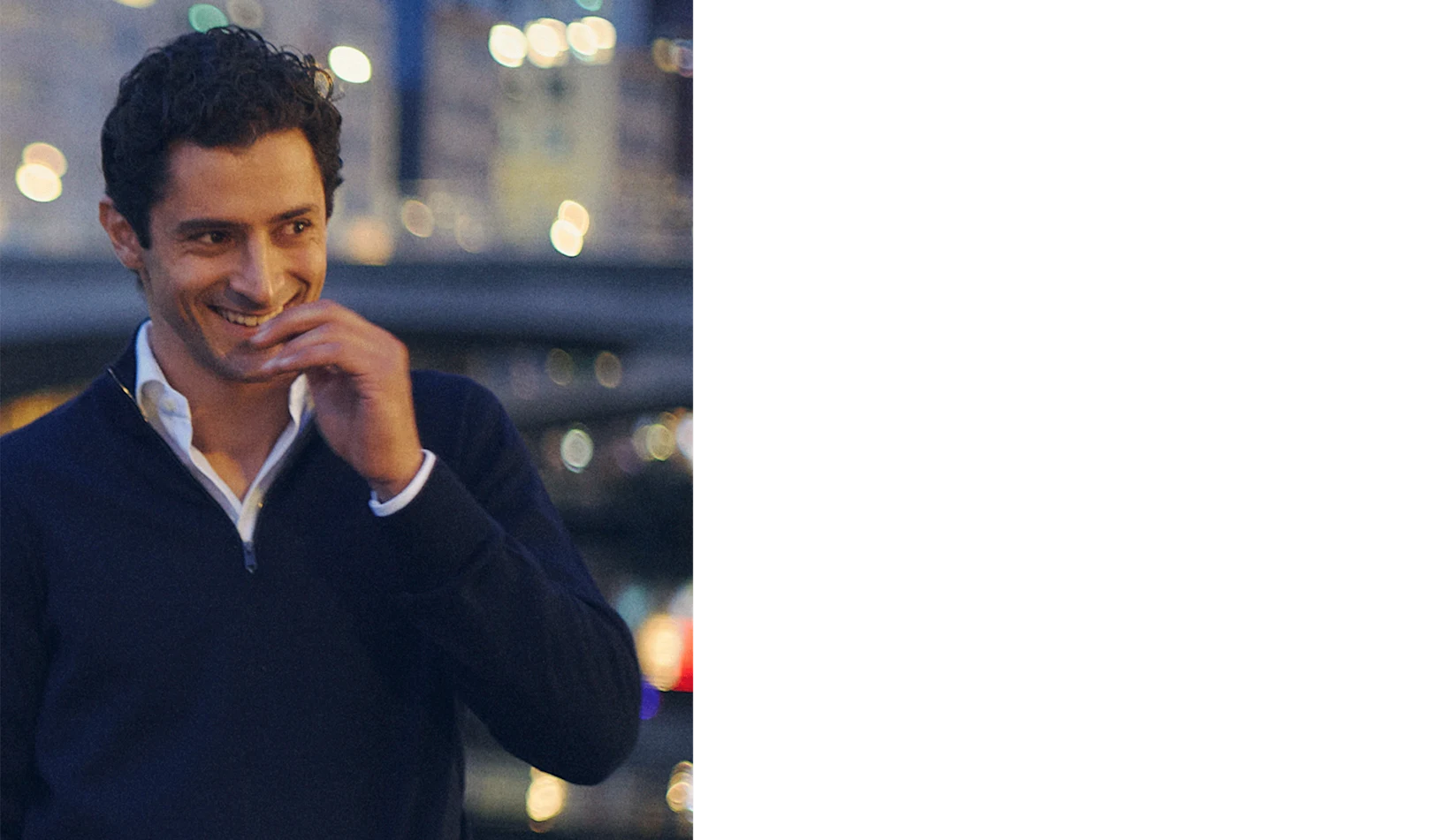 a man posing in the evening in a white signature twill shirt and a navy quarter zip