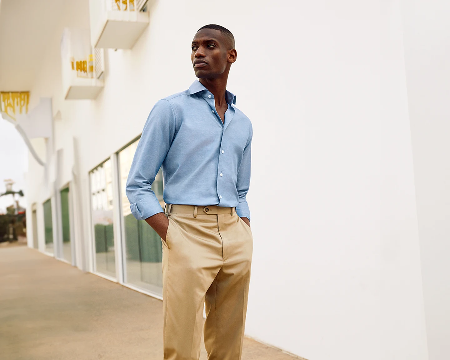 model in beige chinos and blue linen shirt