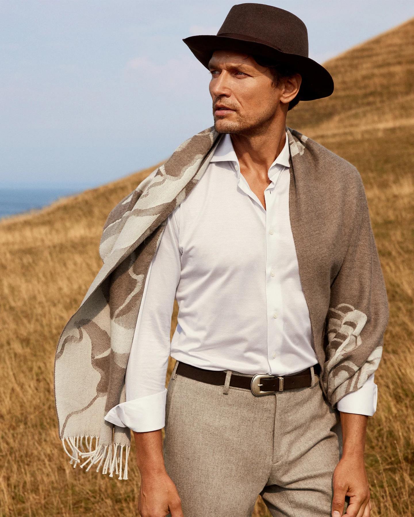 model in white shirt hat and woolscarf