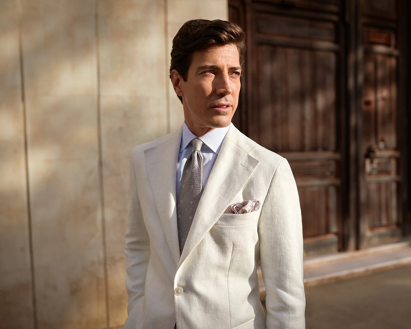 model in beige suit and lightblue shirt with tie