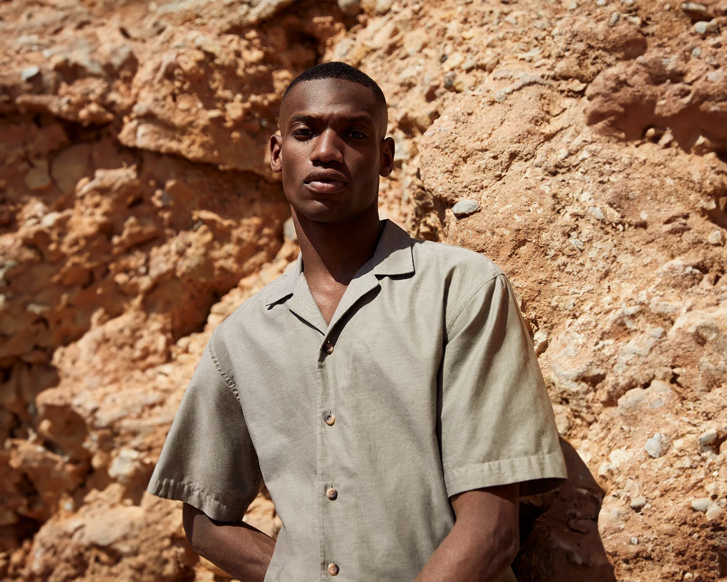 model in green linen resort shirt