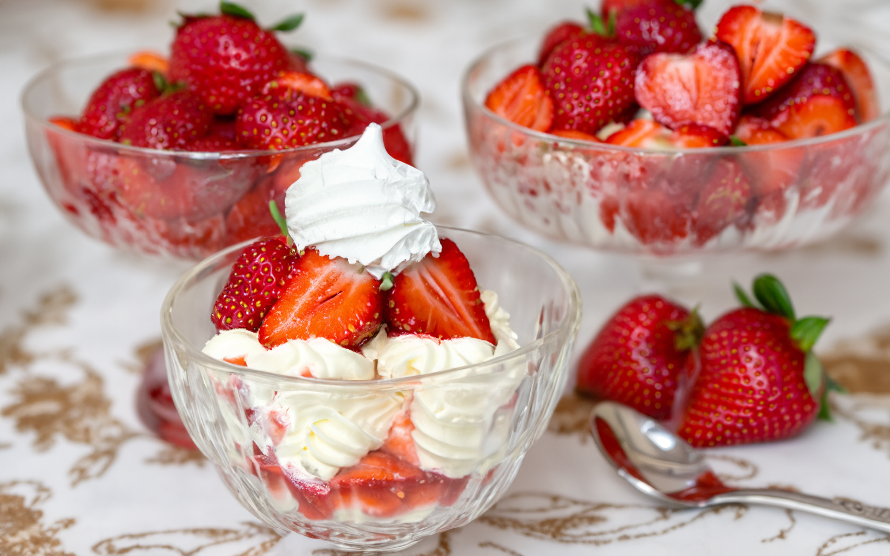 an image of a dessert with vanilla ice cream, strawberries, meringue nests and whipped cream