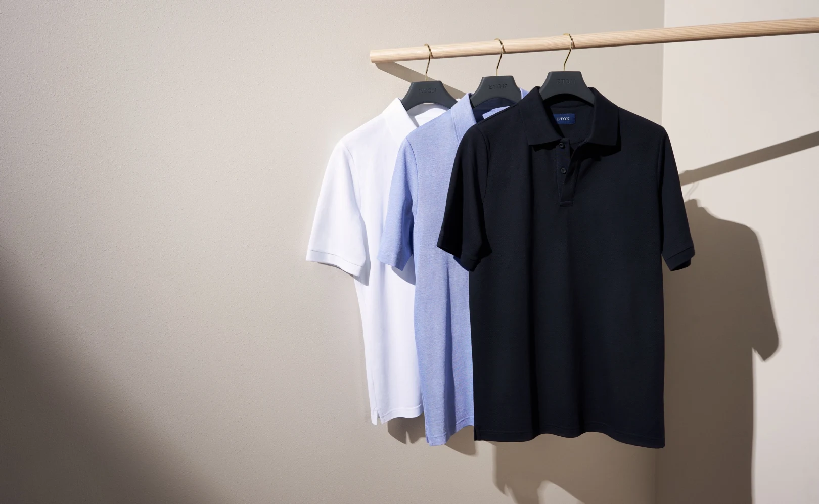 short sleeved shirts on rack hanging