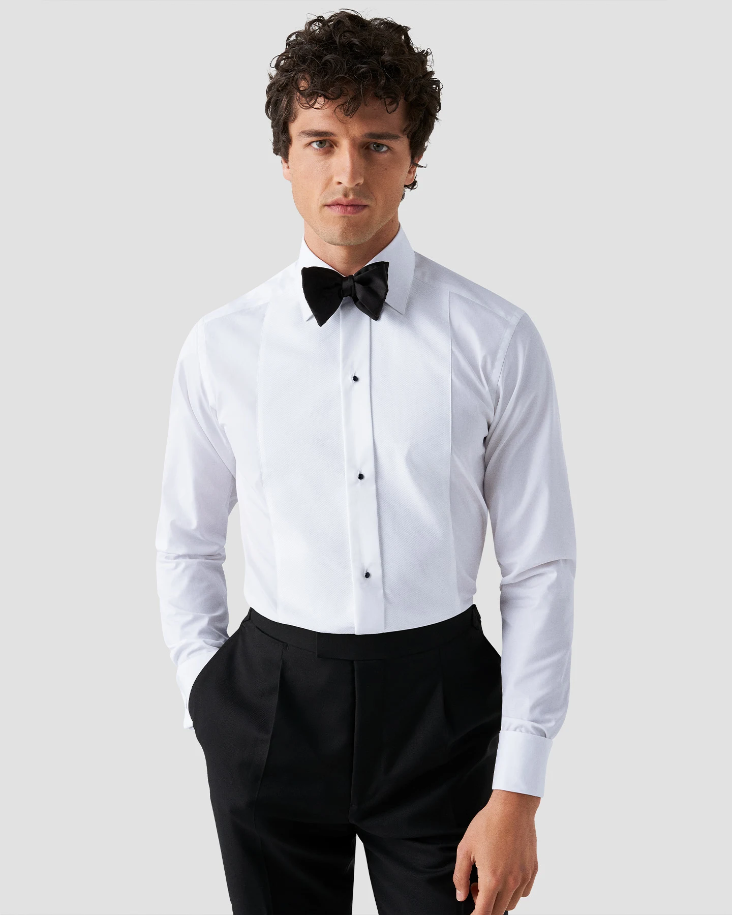 Model with tuxedo shirt and bowtie