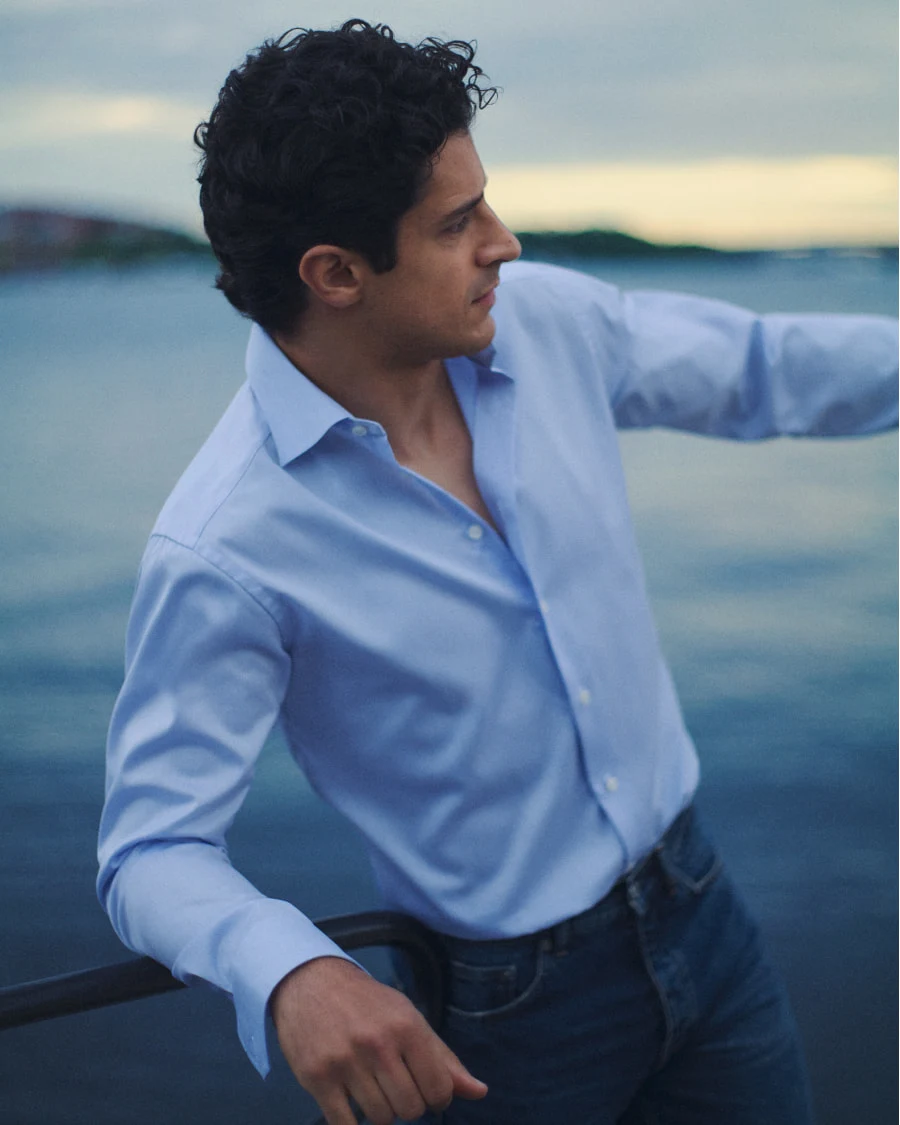 Man posing in a light bluesignature twill shirt highlighting the cuff