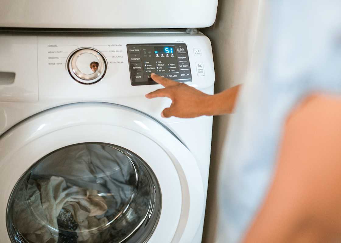 Person-setting-washing-machine-program