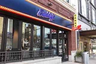 An exterior, street-level photo of the entrance to Buddy’s Pizza at The Madison.