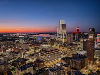 Aerial of Hudson’s Detroit, featuring the Block building in the foreground and the Edition tower in the background, taken at nighttime.