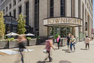 An exterior photograph of the Townhouse entrance at Ally Detroit Center.