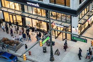An exterior photo of 1449 Woodward, featuring Warby Parker and Lululemon storefronts.