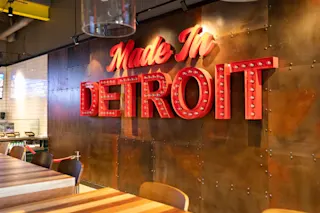 An interior photo of a sign at Buddy’s Pizza at The Madison.