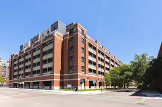 An exterior photo of River Place Garage from street level, not featuring the building’s murals.