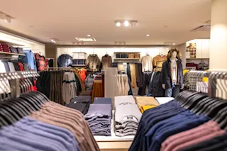 An interior photo of the clothing racks at H&M at 1529 Woodward.