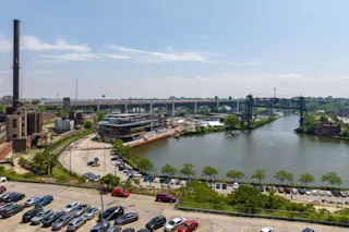 An aerial photo of the Downtown Cleveland Riverfront, featuring the Cleveland Clinic Global Peak Performance Center under construction.