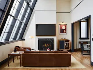 Living room with fireplace and lounge area at Shinola Hotel. 