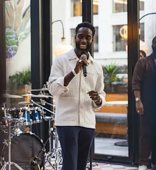 Man speaks at an event. 