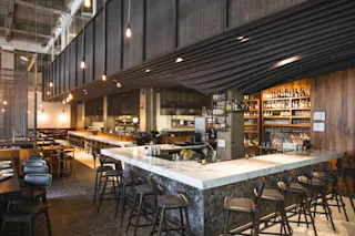 An interior photo of Soraya at the Federal Reserve Building, featuring the bar and some additional seating.