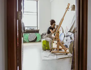 An artist works in their studio. 